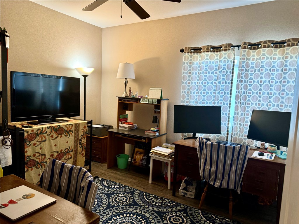 37041 Populus Avenue Palmdale, CA 93552 - Photo 10 of 30 a view of a livingroom with workspace and a flat screen tv