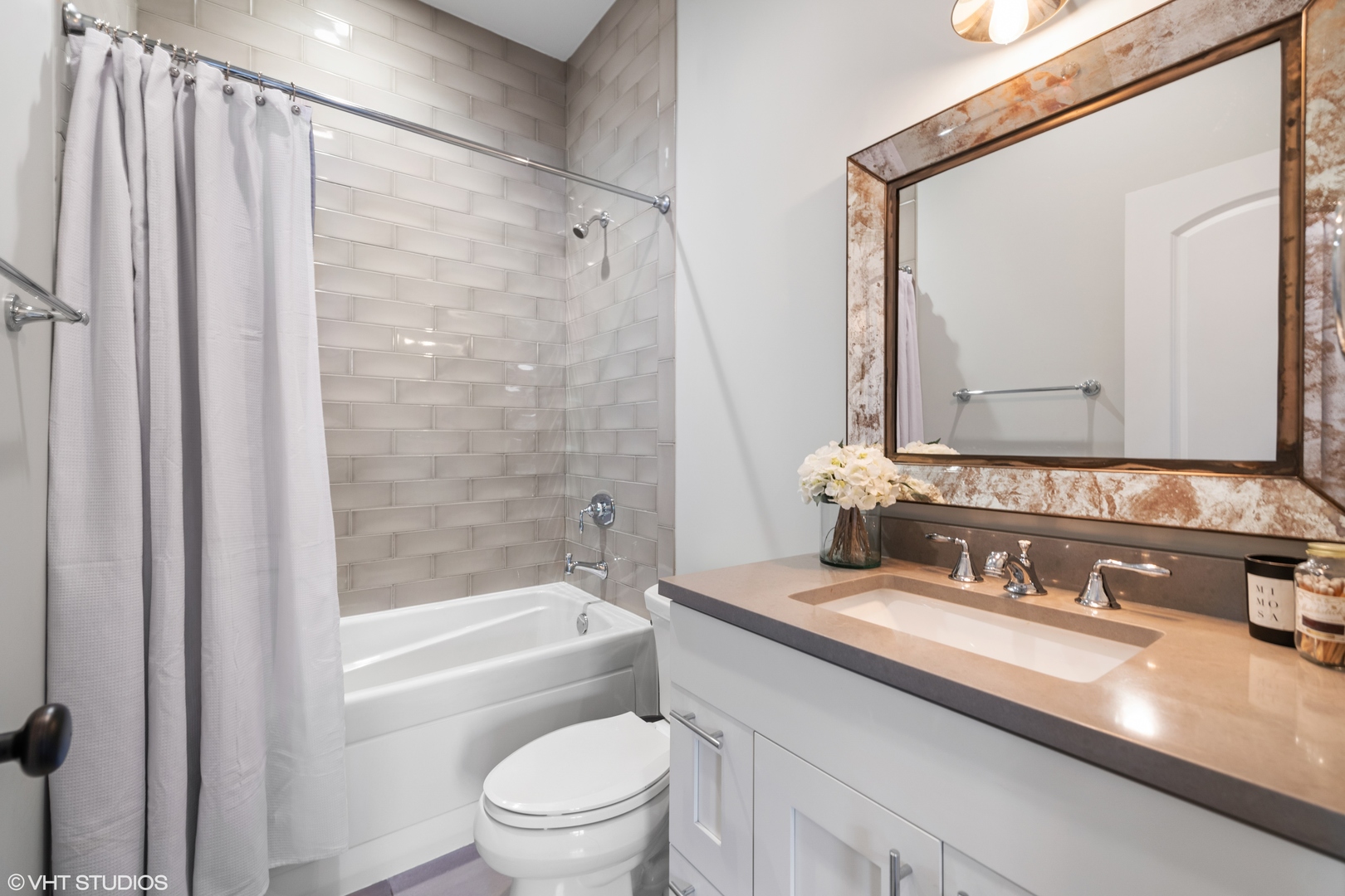 1944 West Fletcher Street, Unit 3E Chicago, IL 60657 - Photo 18 of 28 a bathroom with a granite countertop sink a mirror a toilet and a bathtub