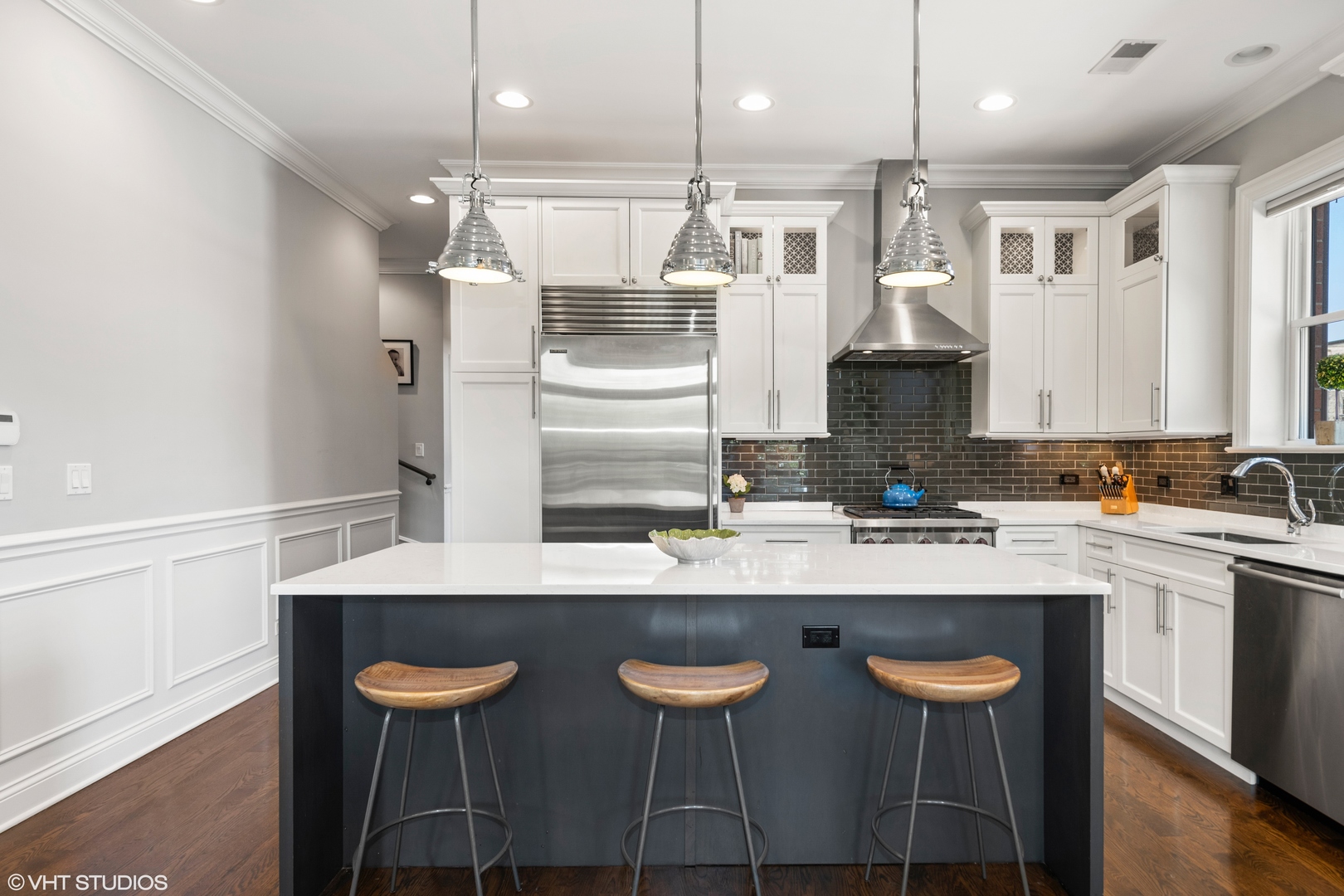 1944 West Fletcher Street, Unit 3E Chicago, IL 60657 - Photo 7 of 28 a kitchen with stainless steel appliances granite countertop a sink a stove a refrigerator and island with wooden floor