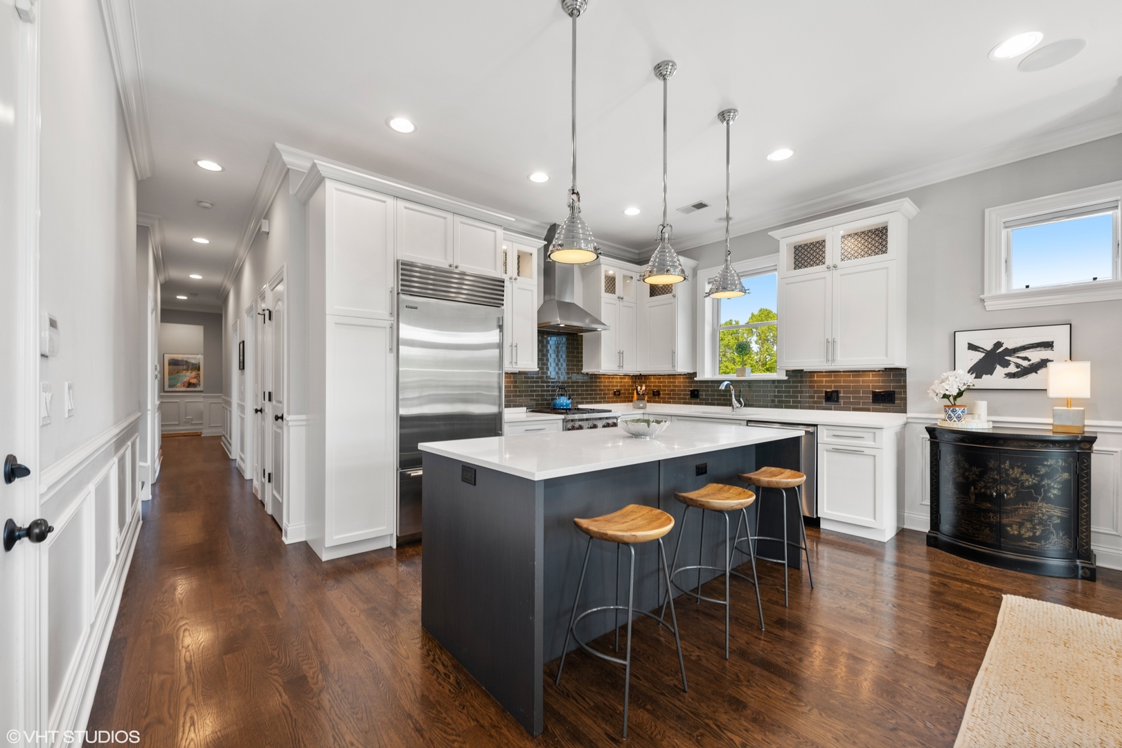 1944 West Fletcher Street, Unit 3E Chicago, IL 60657 - Photo 8 of 28 a kitchen with kitchen island granite countertop a sink a counter space and stainless steel appliances