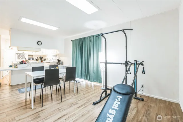 a dining room with furniture and wooden floor