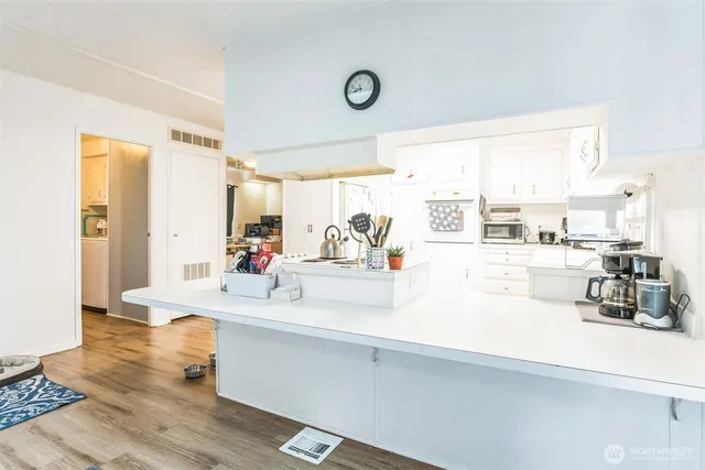 a living room with kitchen island granite countertop furniture and a large window