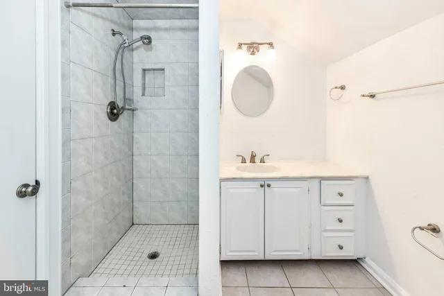 a bathroom with a double vanity sink a mirror and a shower