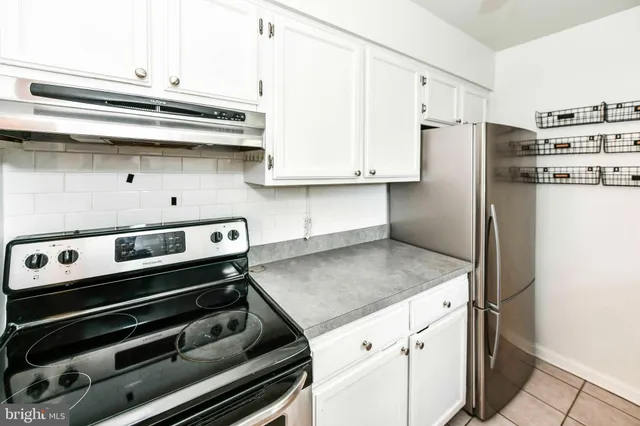 a kitchen with stainless steel appliances granite countertop a refrigerator and a stove