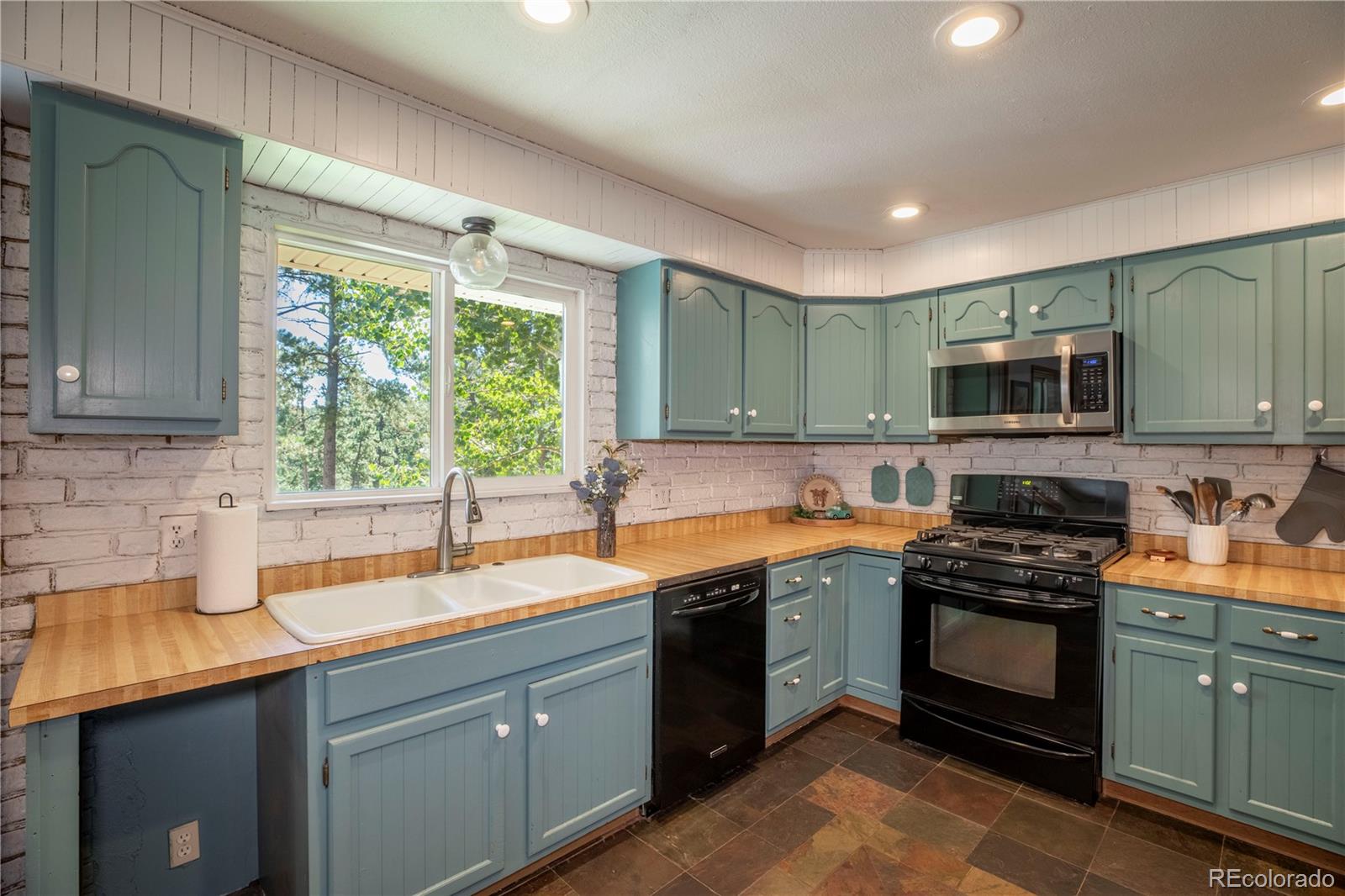 12322 South Wamblee Valley Road Conifer, CO 80433 - Photo 21 of 37 a kitchen with a sink stove top oven and cabinets