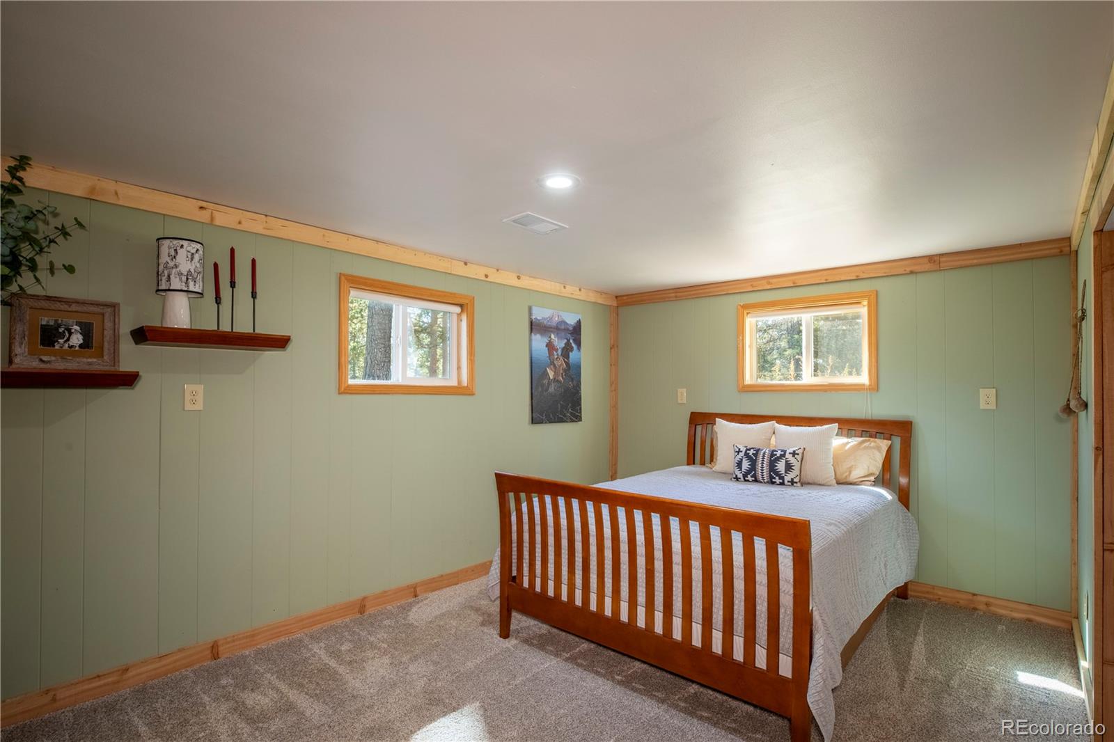 12322 South Wamblee Valley Road Conifer, CO 80433 - Photo 31 of 37 a bedroom with a bed and wall painting