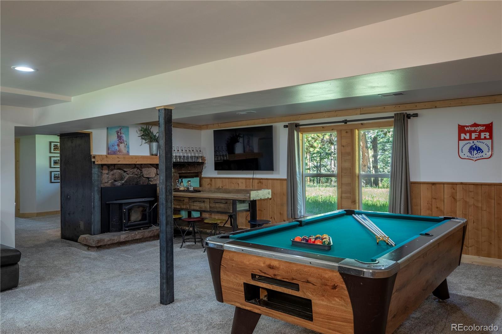 12322 South Wamblee Valley Road Conifer, CO 80433 - Photo 33 of 37 a room with furniture and a flat screen tv