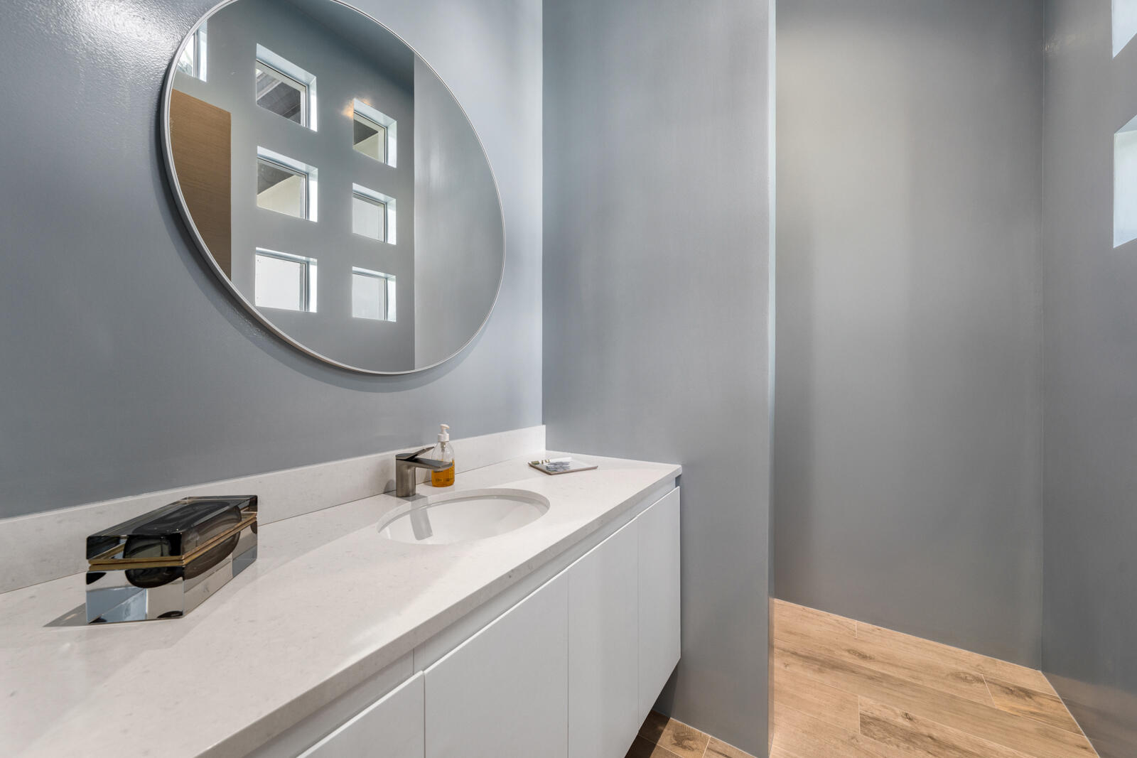 1900 Sabal Palm Drive Boca Raton, FL 33432 - Photo 35 of 75 a bathroom with a sink and a mirror