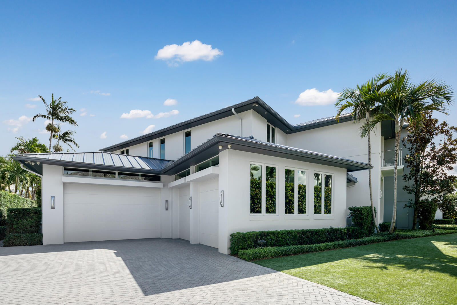 1900 Sabal Palm Drive Boca Raton, FL 33432 - Photo 61 of 75 a front view of a house with a yard and garage