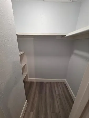 a view of walk in closet with empty racks