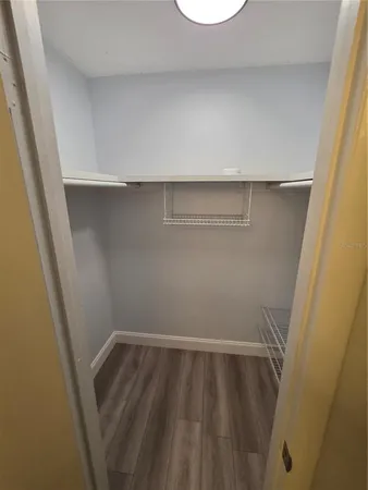 a view of a room with wooden floor