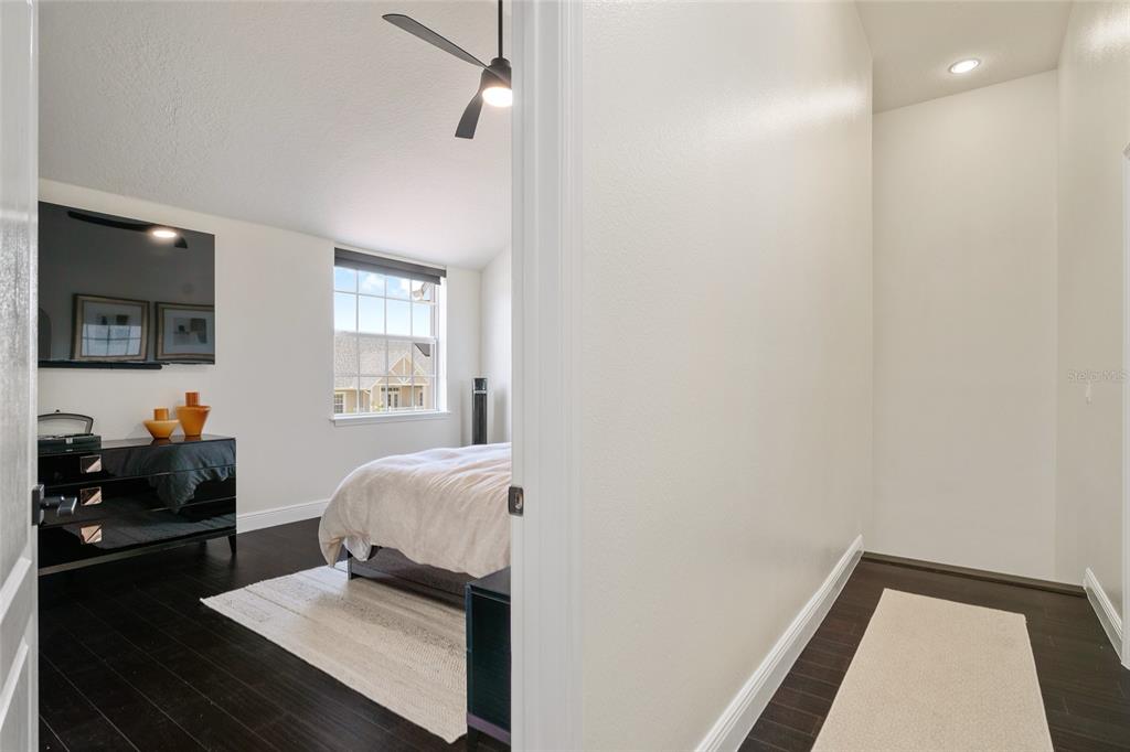 152 Riggings Way Clermont, FL 34711 - Photo 42 of 68 a bedroom with a bed and wooden floor