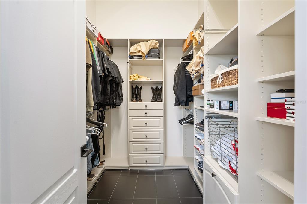 152 Riggings Way Clermont, FL 34711 - Photo 53 of 68 a view of walk in closet with clothes and shoes