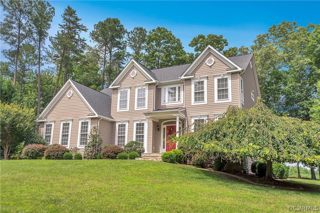 10705 Chatham Ridge Way Spotsylvania, VA 22551 - Photo 1 of 40 a front view of a house with a garden