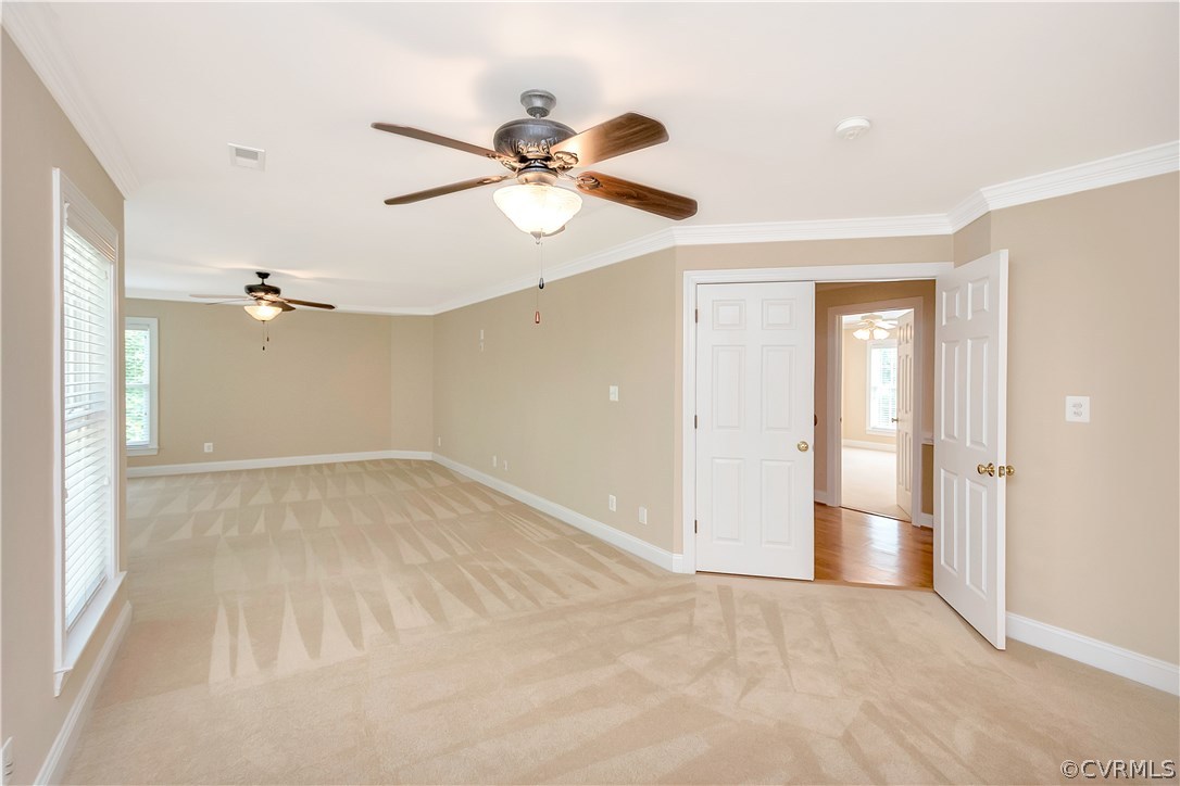 10705 Chatham Ridge Way Spotsylvania, VA 22551 - Photo 16 of 40 an empty room with a ceiling fan and a window