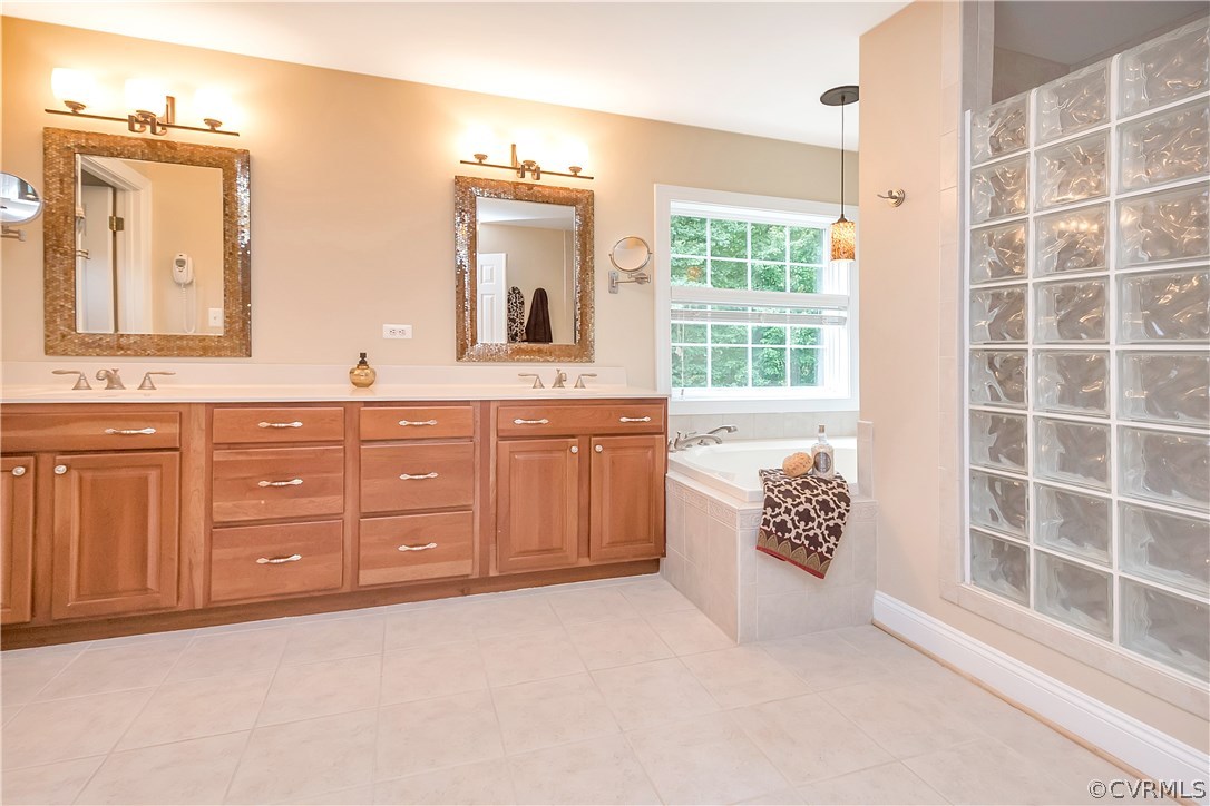 10705 Chatham Ridge Way Spotsylvania, VA 22551 - Photo 18 of 40 a spacious bathroom with a granite countertop sink mirror and