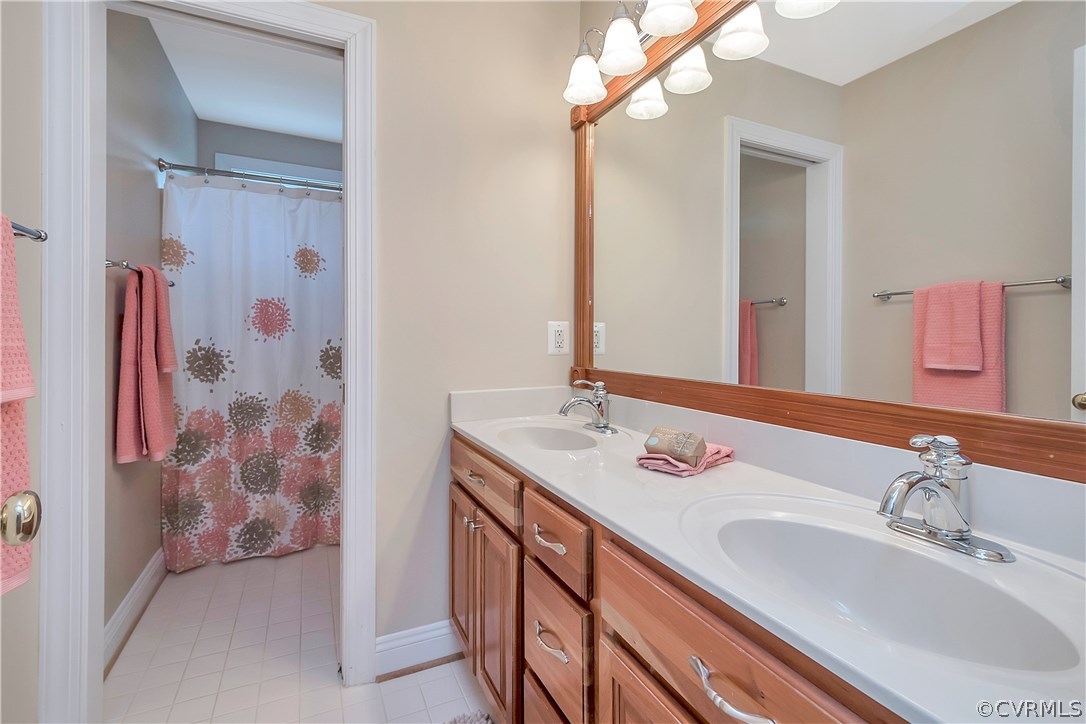 10705 Chatham Ridge Way Spotsylvania, VA 22551 - Photo 23 of 40 a bathroom with a sink a vanity and a mirror