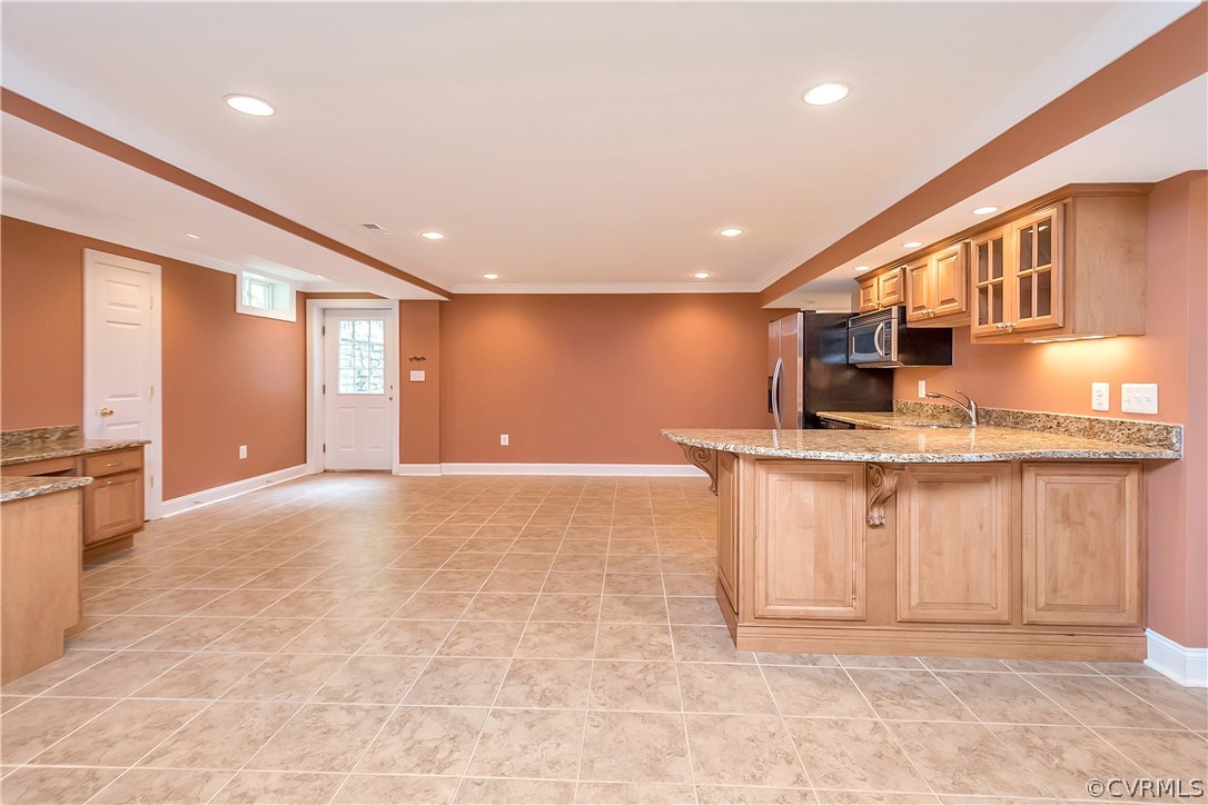 10705 Chatham Ridge Way Spotsylvania, VA 22551 - Photo 26 of 40 a view of kitchen with stainless steel appliances granite countertop cabinets and living room