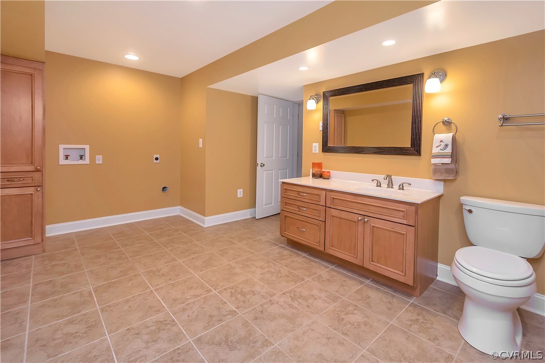 10705 Chatham Ridge Way Spotsylvania, VA 22551 - Photo 29 of 40 a bathroom with a toilet sink vanity and mirror