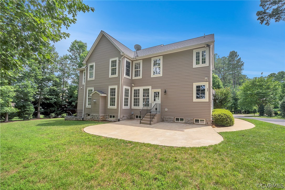 10705 Chatham Ridge Way Spotsylvania, VA 22551 - Photo 30 of 40 a view of a house with a backyard and a patio