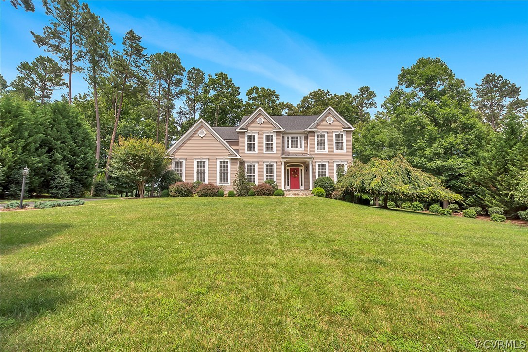 10705 Chatham Ridge Way Spotsylvania, VA 22551 - Photo 32 of 40 a front view of a house with a garden
