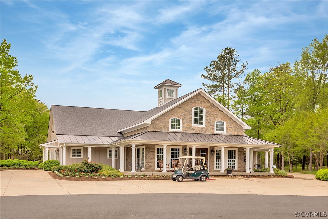 10705 Chatham Ridge Way Spotsylvania, VA 22551 - Photo 39 of 40 a front view of a building with a garden and plants