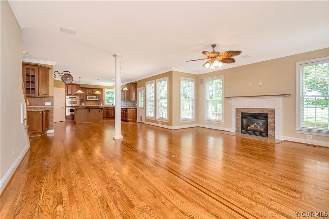 10705 Chatham Ridge Way Spotsylvania, VA 22551 - Photo 6 of 40 an empty room with wooden floor and a fireplace