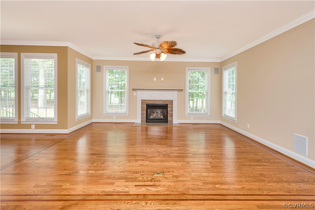 10705 Chatham Ridge Way Spotsylvania, VA 22551 - Photo 7 of 40 a view of an empty room with wooden floor fireplace and a window