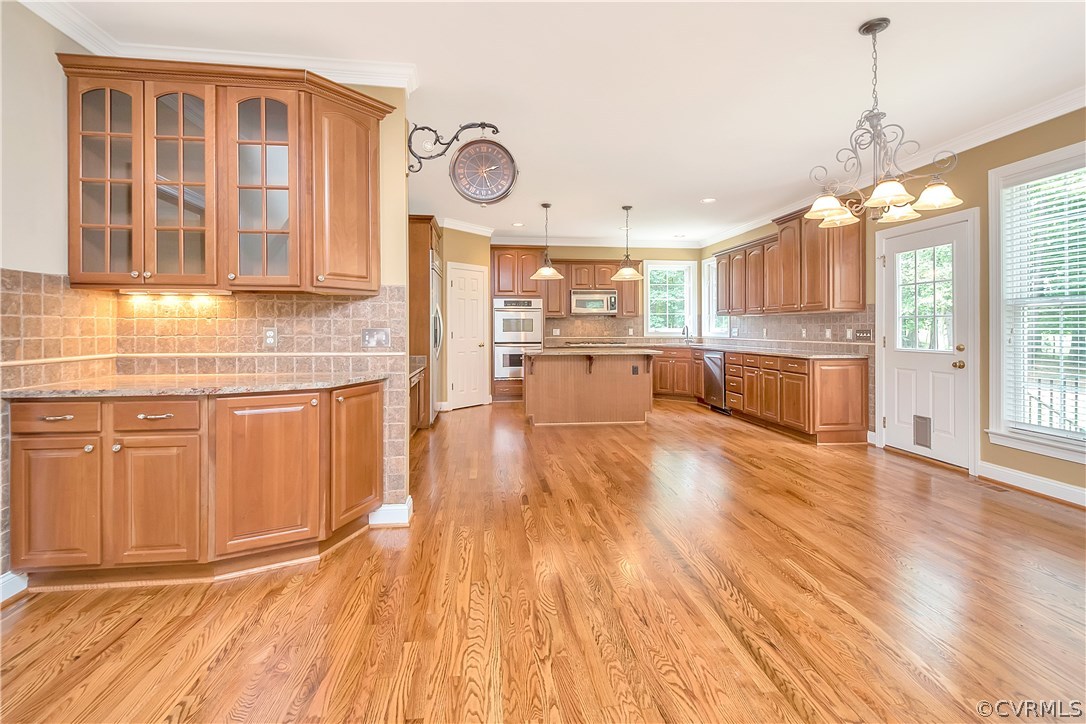 10705 Chatham Ridge Way Spotsylvania, VA 22551 - Photo 10 of 40 a large kitchen with lots of counter space and wooden floor