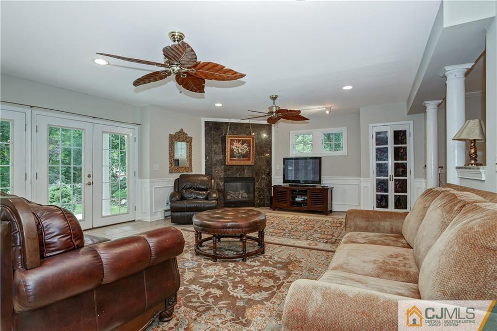 16 Oak Hills Road Edison, NJ 08820 - Photo 8 of 25 a living room with fireplace furniture and a large window