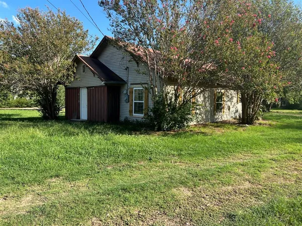 a front view of house with a garden