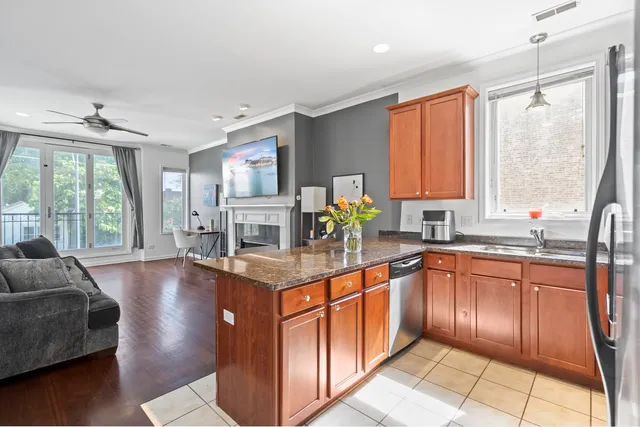 a kitchen with stainless steel appliances granite countertop sink stove and wooden cabinets