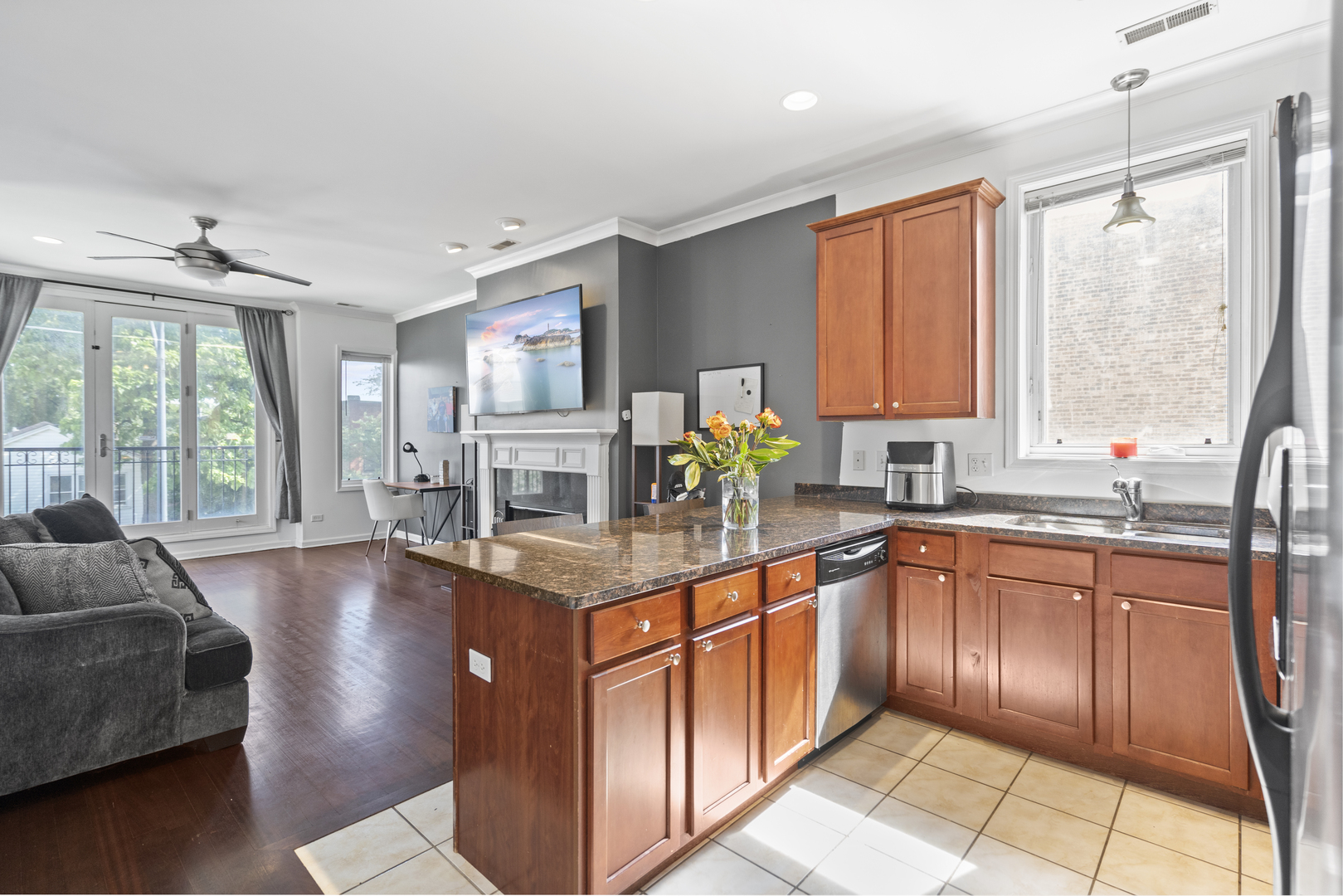 2539 West Warren Boulevard, Unit 2 Chicago, IL 60612 - Photo 2 of 14 a kitchen with stainless steel appliances granite countertop sink stove and wooden cabinets