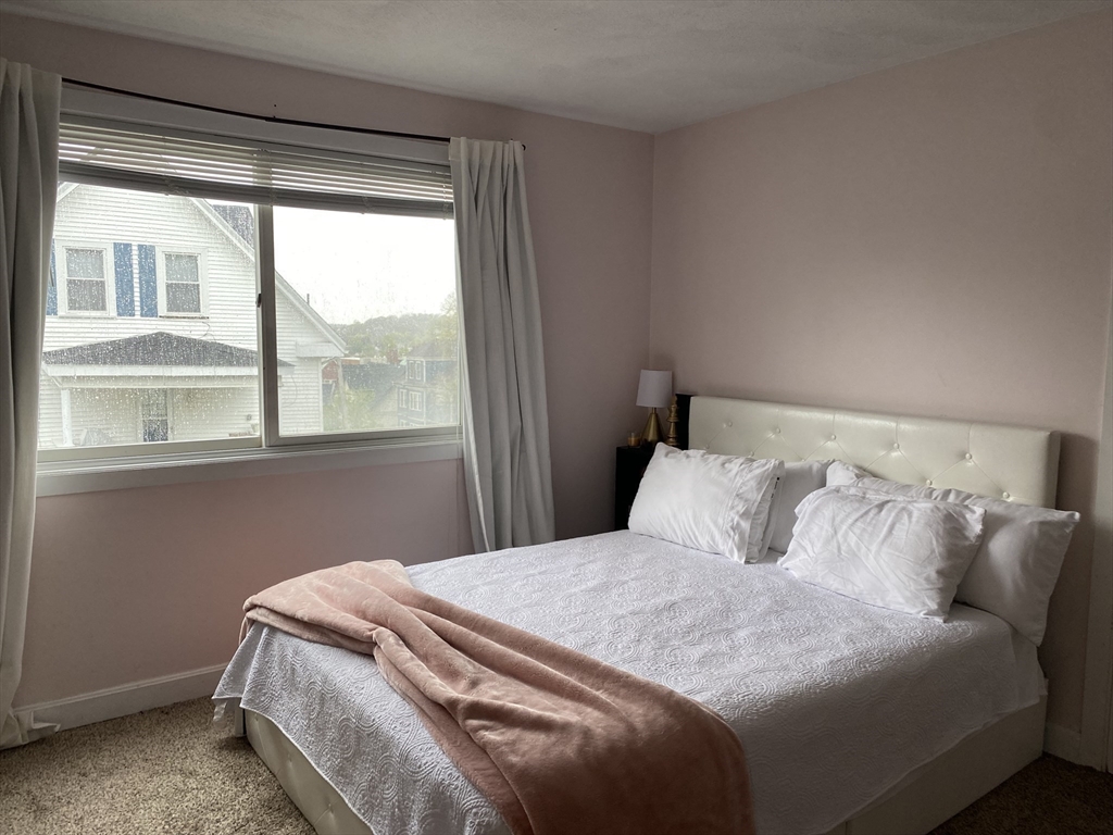 133 Walnut Street, Unit 2 Malden, MA 02148 - Photo 7 of 10 a bedroom with a bed and a window