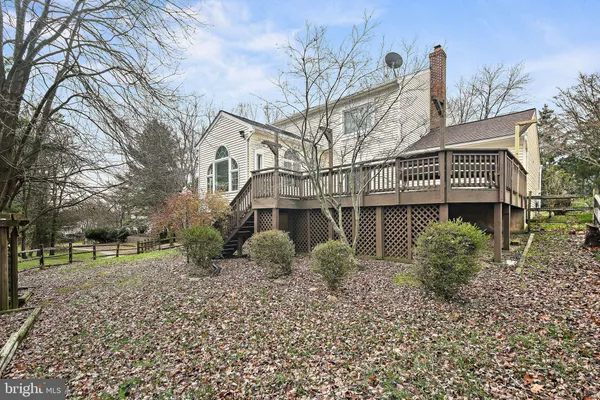 a view of a house with a yard and potted plants