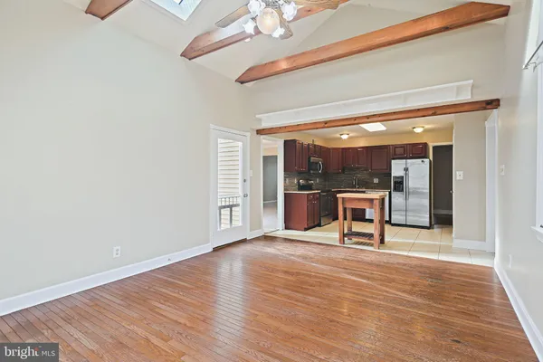 a view of a room with wooden floor