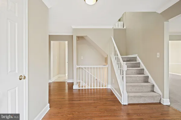 a view of entryway and hall with wooden floor