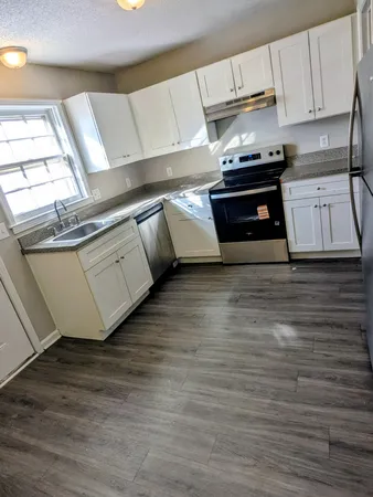 a kitchen with stainless steel appliances granite countertop a sink and a stove