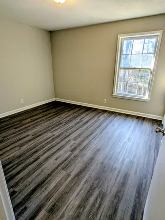 a view of an empty room and wooden floor
