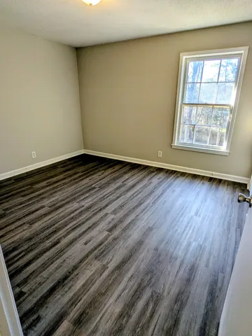 a view of an empty room and wooden floor