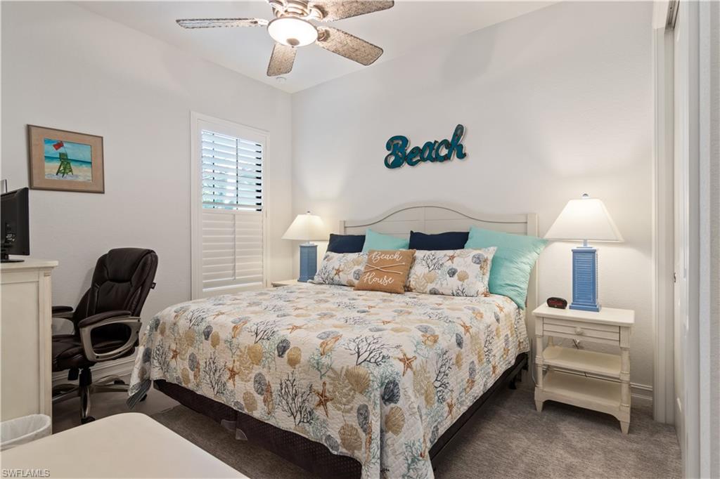 6604 Roma Way Naples, FL 34113 - Photo 12 of 21 a bedroom with a bed and a lamp on dresser