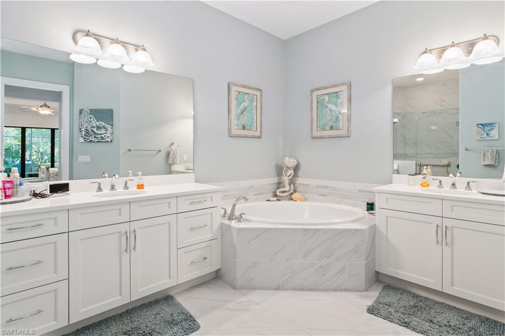 6604 Roma Way Naples, FL 34113 - Photo 14 of 21 a bathroom with double sink and a mirror