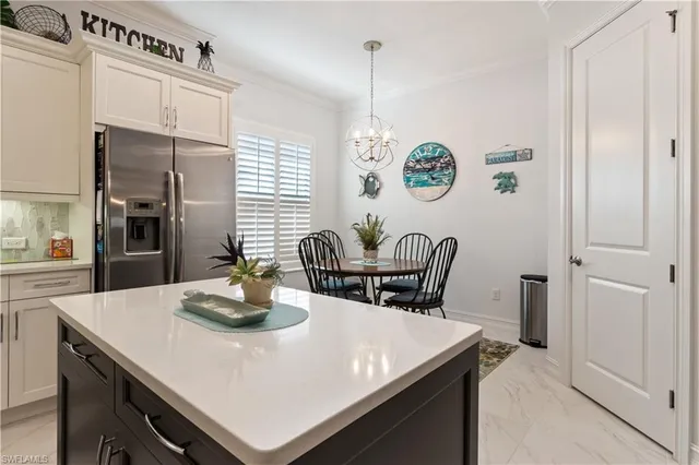a kitchen with a table chairs and a refrigerator