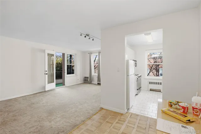 a kitchen with stainless steel appliances white cabinets and a window