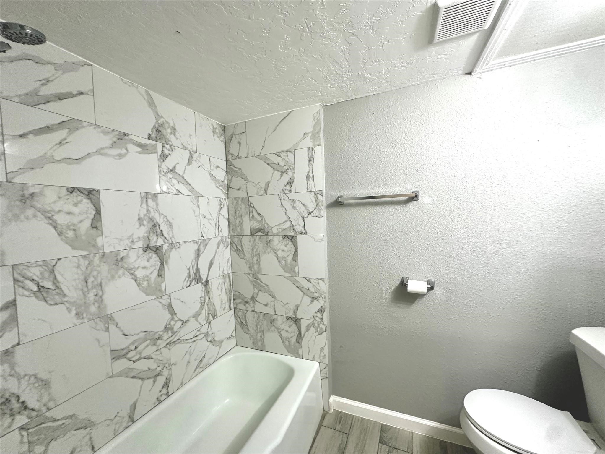 5418 Weaver Road, Unit A Houston, TX 77016 - Photo 7 of 9 a bathroom with a bathtub and shower