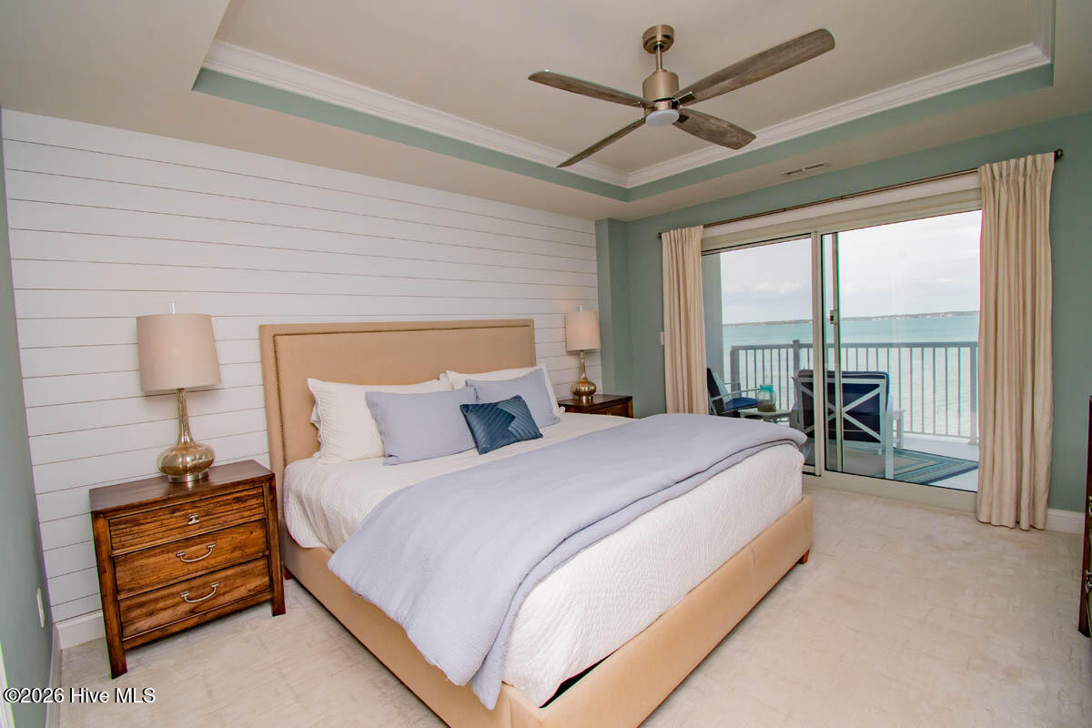 1550 Salter Path Road, Unit 409 Indian Beach, NC 28512 - Photo 14 of 46 Primary bedroom with direct balcony access.