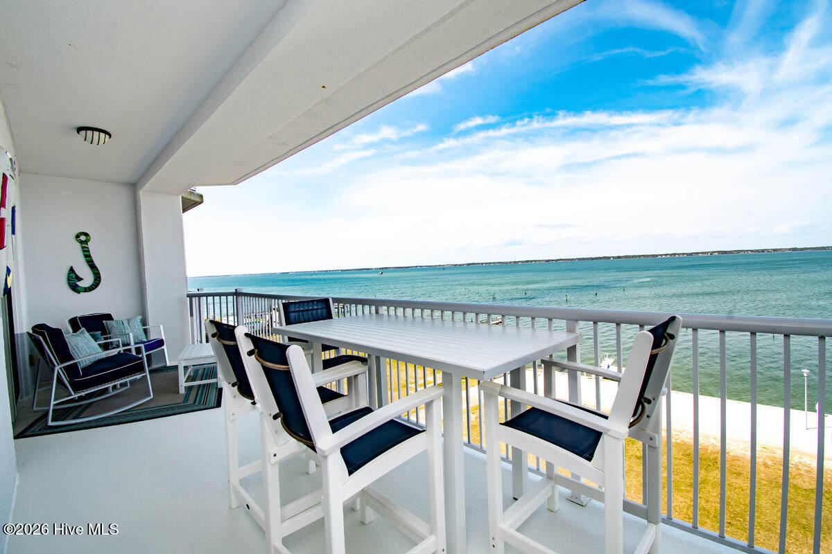 1550 Salter Path Road, Unit 409 Indian Beach, NC 28512 - Photo 2 of 45 Covered balcony provides front row seats to sunsets over Bogue Sound.