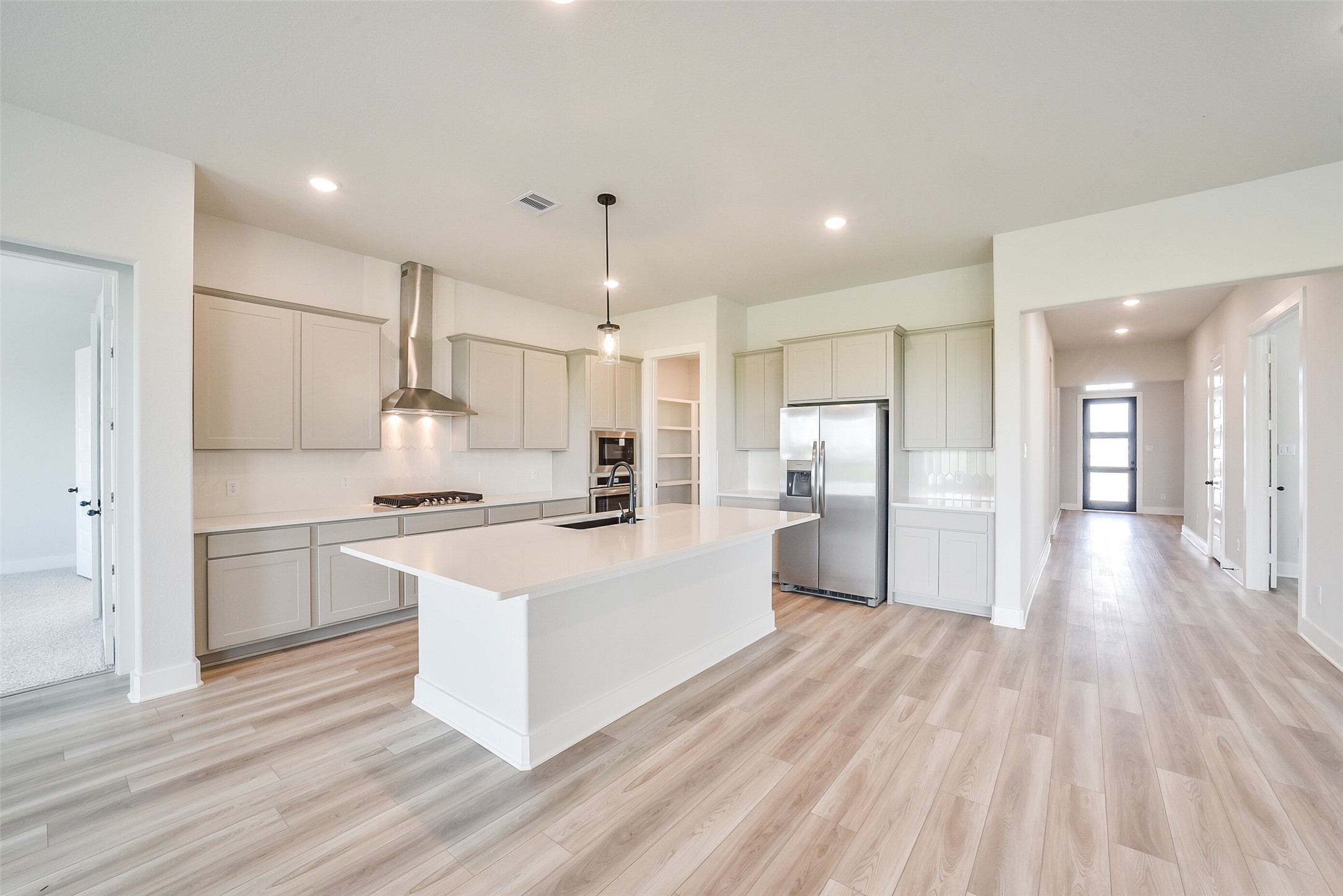 1831 Tioga Vw Drive Rosharon, TX 77583 - Photo 19 of 50 a large white kitchen with a refrigerator a sink dishwasher and a stove with wooden floor