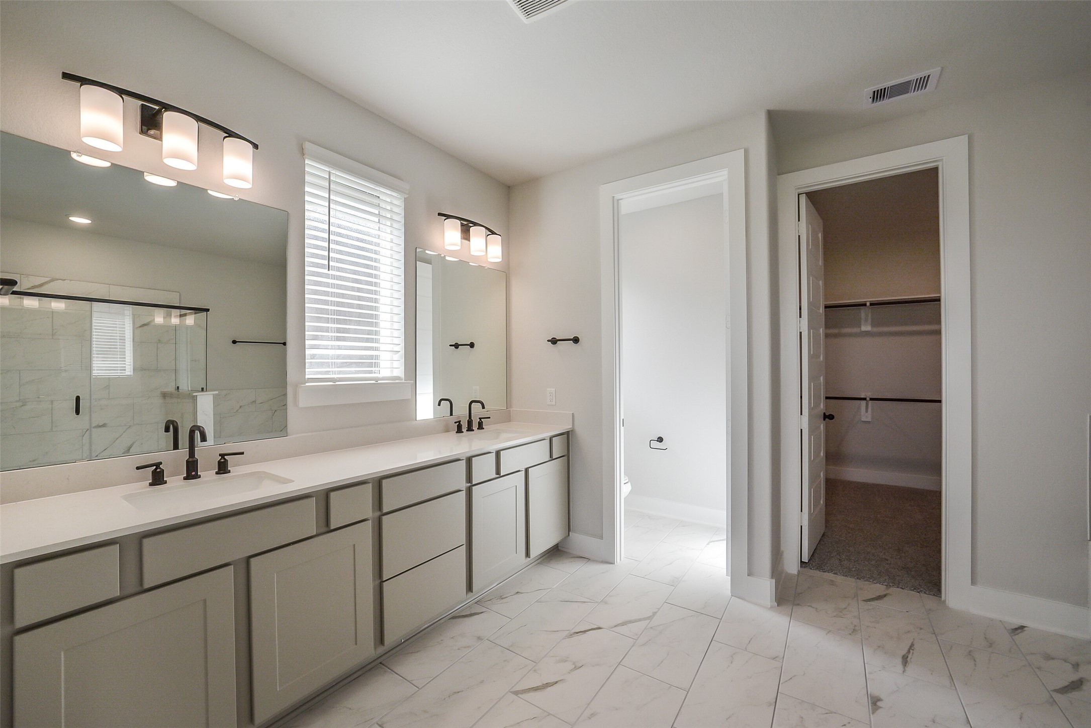 1831 Tioga Vw Drive Rosharon, TX 77583 - Photo 36 of 50 a spacious bathroom with a mirror sink and shower
