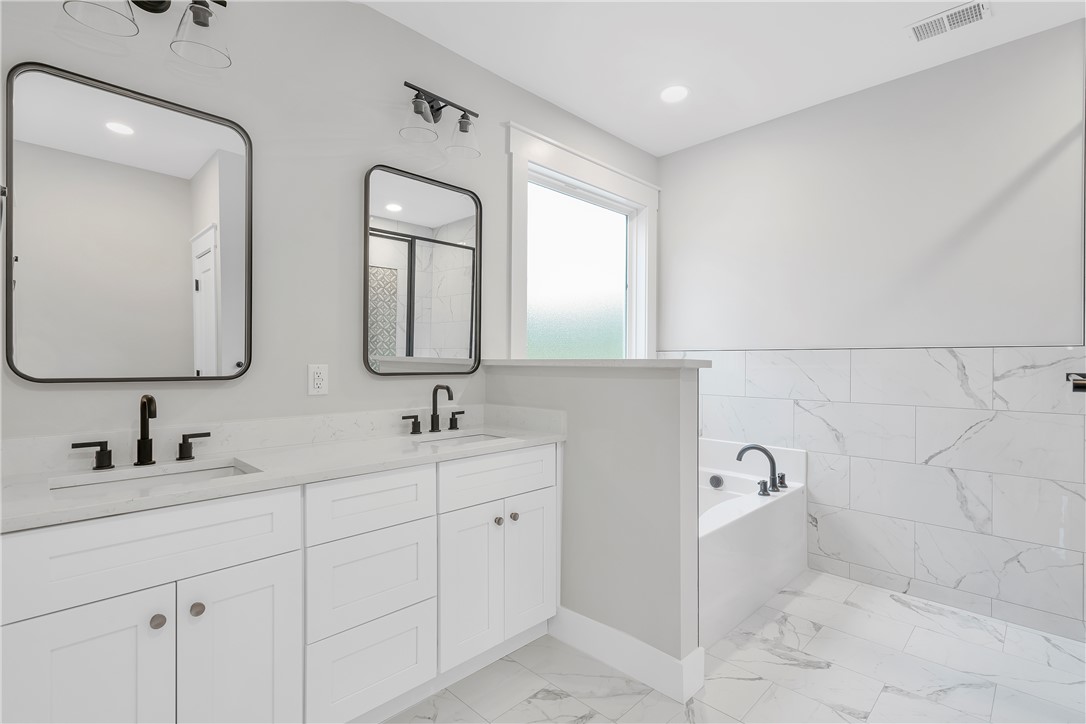 4554 Flat Rock Road Iva, SC 29655 - Photo 23 of 32 Luxurious ensuite with a spacious soaking tub and an elegant dual vanity.